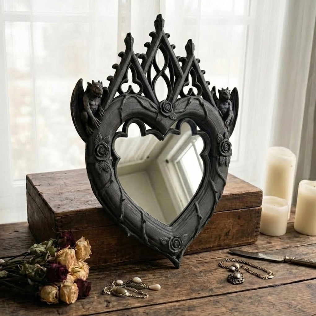 Black Gothic heart mirror styled with candles, dried flowers, and jewelry
