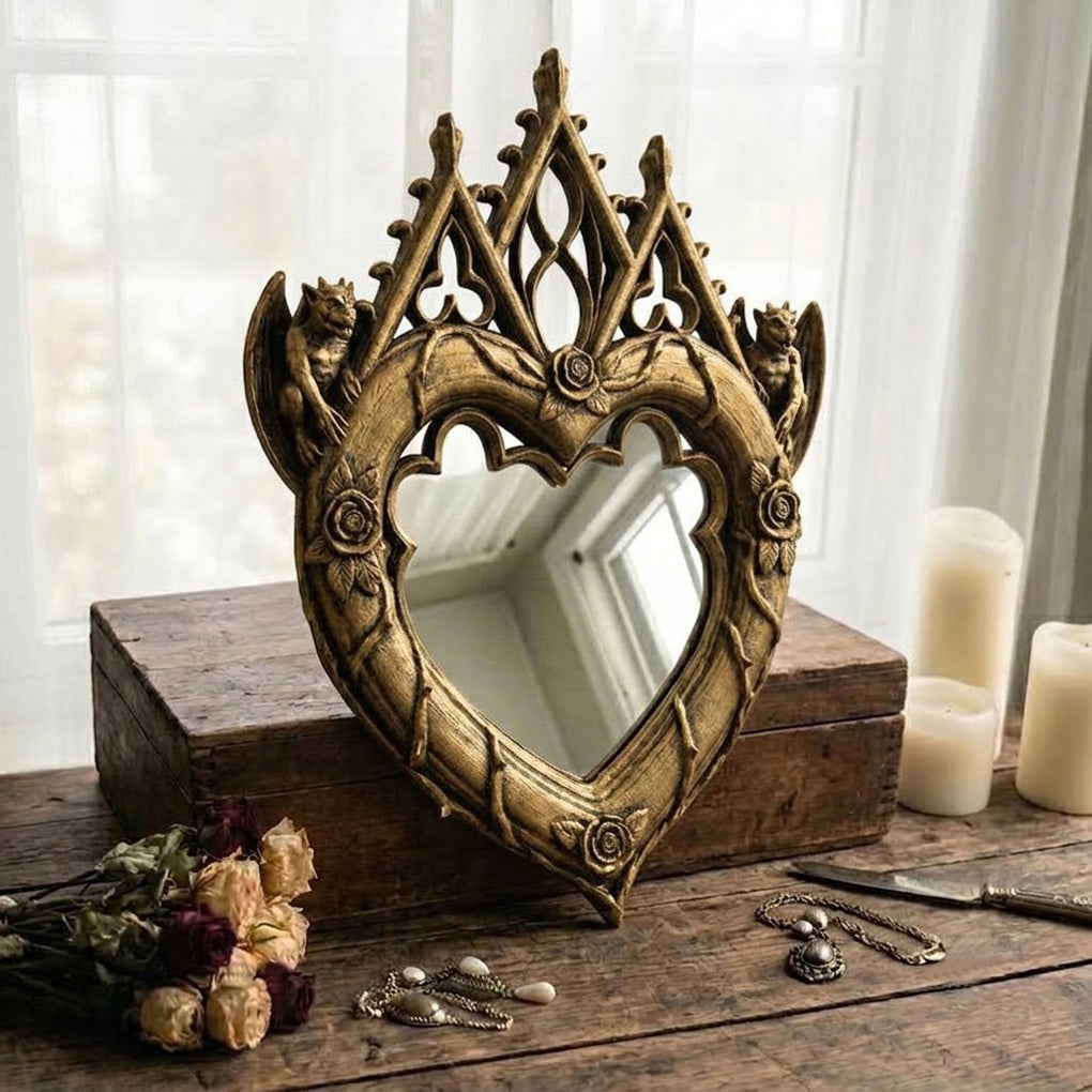 Antique gold Gothic heart mirror with sculpted arches and carved rose details