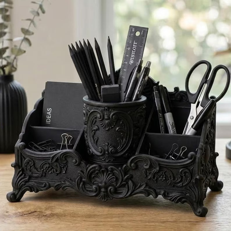 Black baroque desk organizer with ornate compartments for pens, brushes, scissors, and stationery