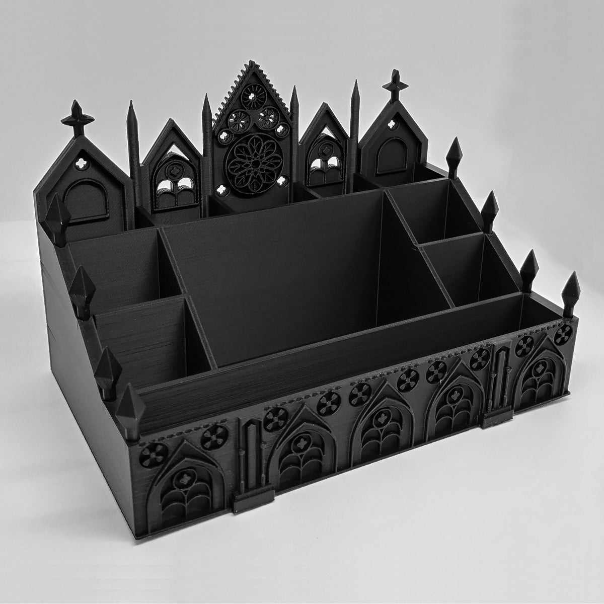 Empty black Gothic Cathedral makeup organizer showing multiple storage compartments on a white background