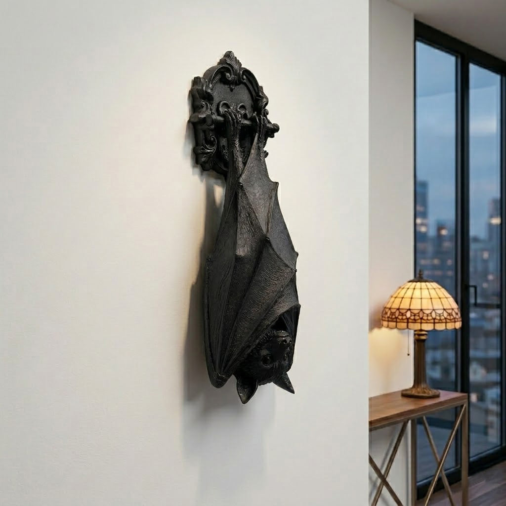 A matte black gothic bat wall decor sculpture hanging in a dark Victorian style room