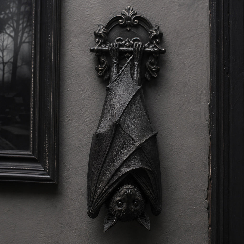 Gothic bat wall decor hanging on a dark wall in Victorian style interior