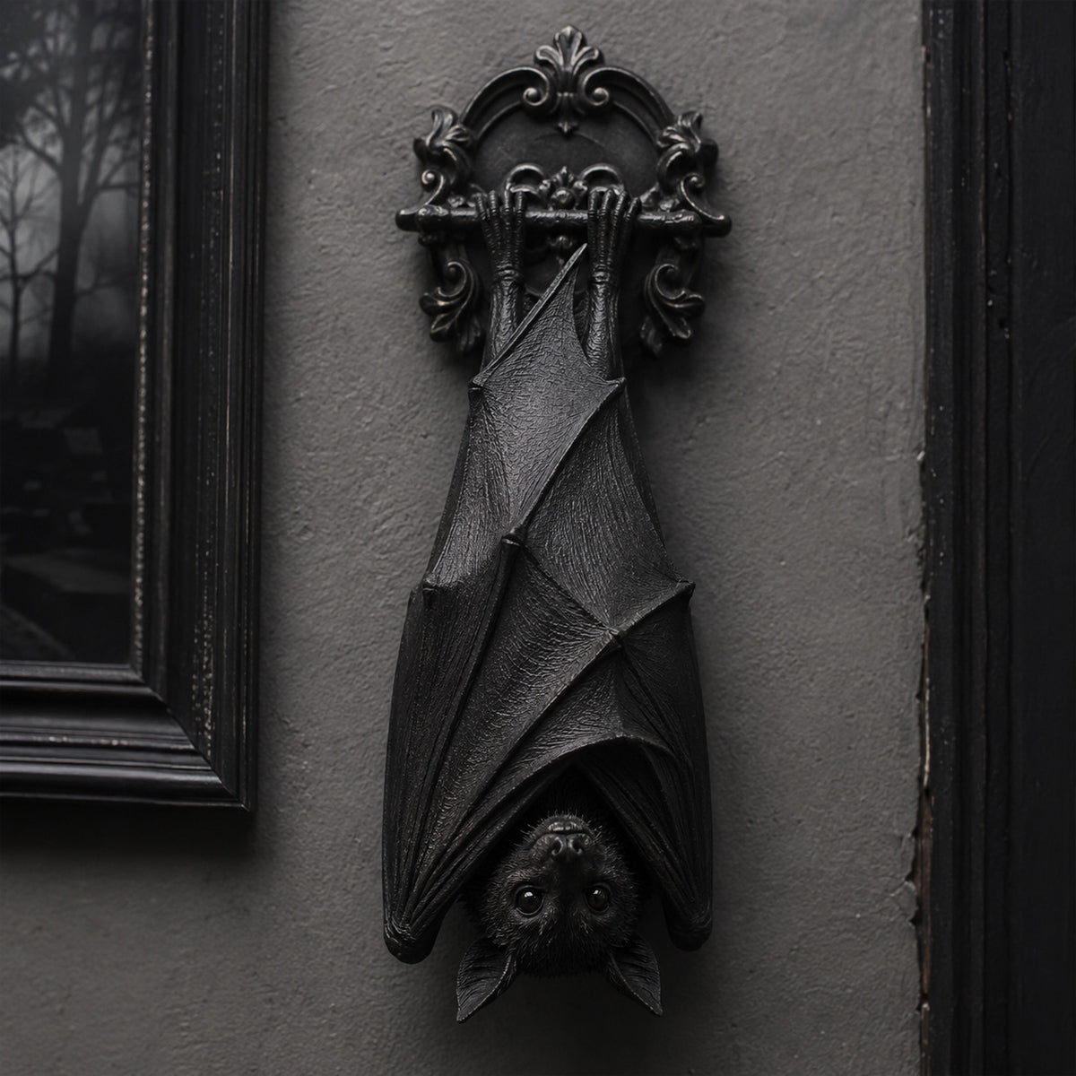 Gothic bat wall decor hanging on a dark wall in Victorian style interior